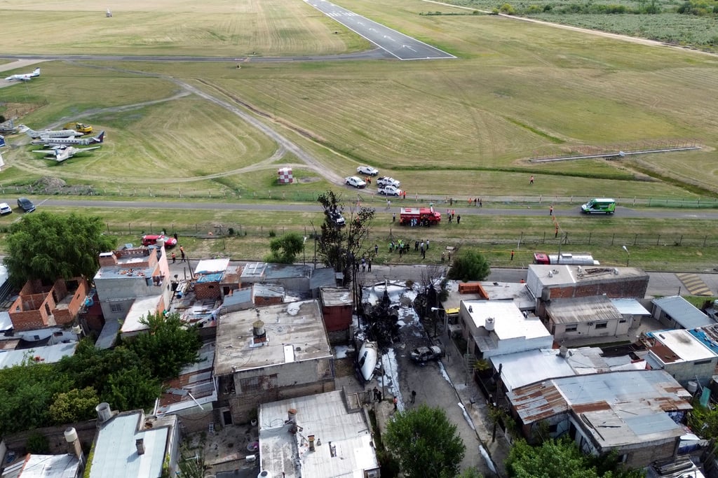 The wreckage of a plane lays next to homes after crashing near the airport in San Fernando, on the outskirts of Buenos Aires, Argentina, Wednesday, Dec. 18, 2024.