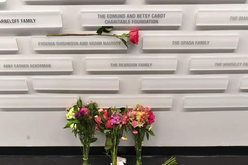 A rose rests near the names of figure skating coaches Evgenia Shishkova and Vadim Naumov on a commemorative wall Thursday, Jan. 30, 2025, at the Skating Club of Boston in Norwood, Mass. The two former world champions who were coaching at the historic Boston club were among the members of the skating community killed when an American Airlines flight collided with an Army helicopter Wednesday, Jan. 29, and crashed into the Potomac River. 