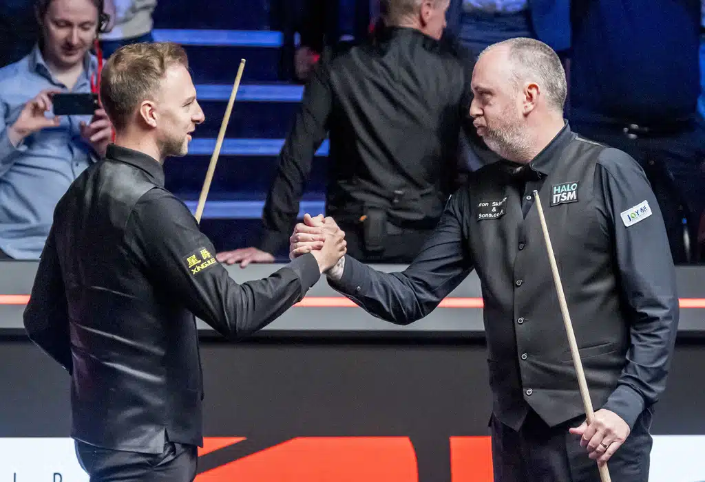 Mark Williams, right, is congratulated by Judd Trump following their match on day 15 of the Halo World Snooker Championship at the Crucible Theatre in Sheffield, England, Saturday May 3, 2025.