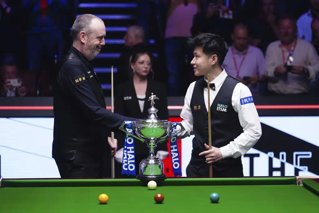 Wales' Mark Williams and China's Zhao Xintong pose with the trophy prior to the Final on day sixteen of the World Snooker Championship at the Crucible Theatre, Sheffield, England, Sunday, May 4, 2025.