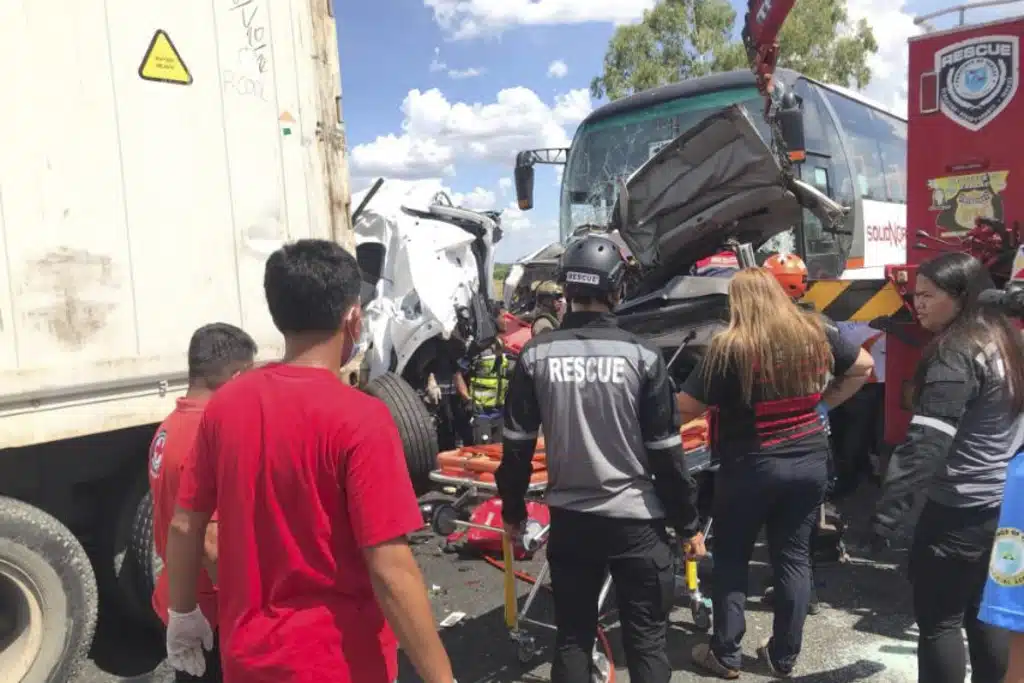 In this handout photo provided by the Philippine Red Cross, rescuers check the site of a multiple-vehicle collision after a speeding passenger bus slammed into a row of vehicles lined up at a highway toll booth killing about a dozen people in Tarlac city, north of Manila, Philippines on Thursday May 1, 2025.