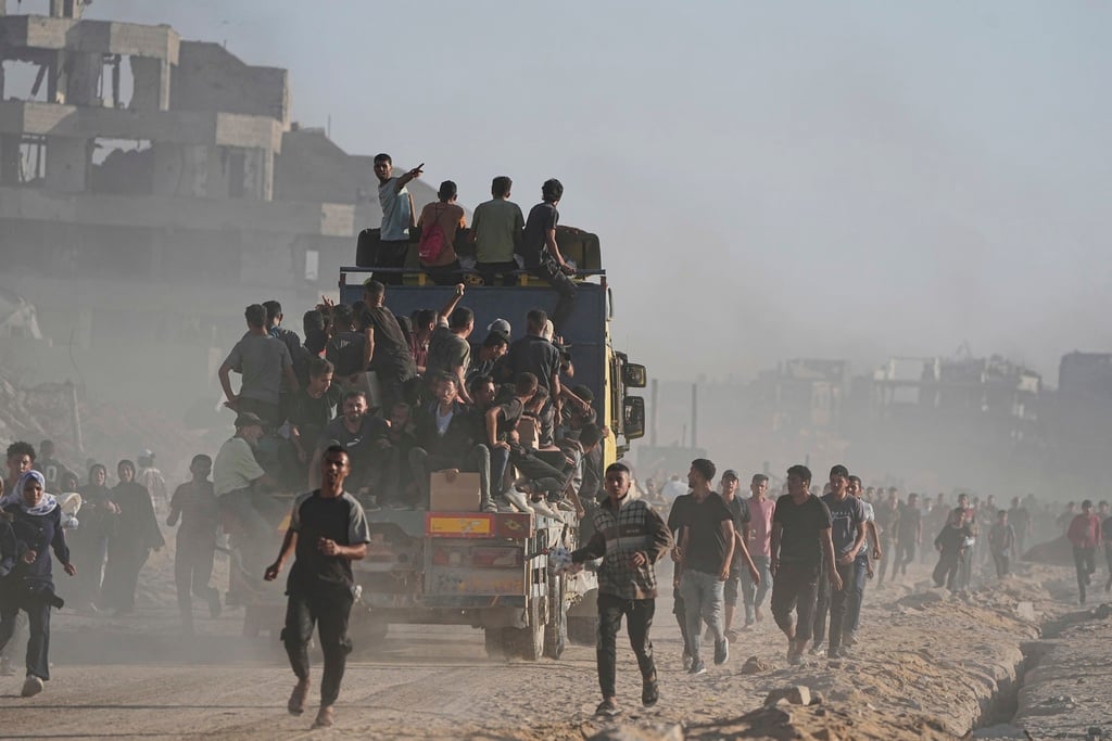 Palestinians ride on a truck loaded with food and humanitarian aid from the World Food Programme, after it arrived in the northern Gaza Strip en route to Gaza City, Monday, June 16, 2025.
