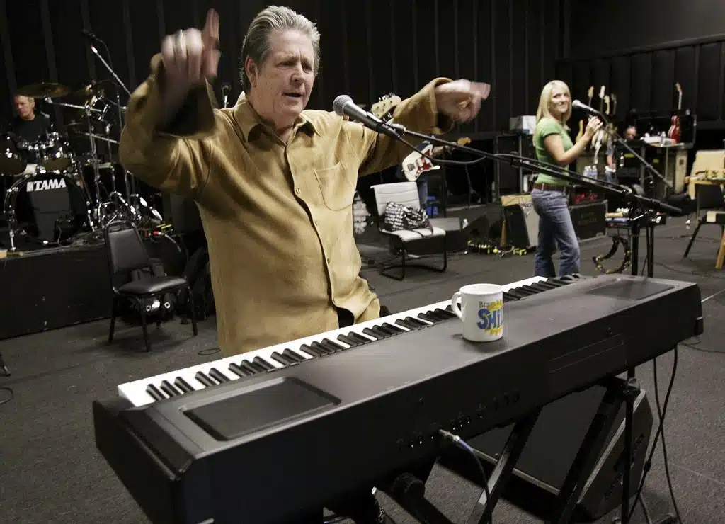 FILE - Brain Wilson, leader of The Beach Boys, performs the song "Heroes and Villains" during a rehearsal at a sound stage in Burbank, Calif., Sept. 22, 2004.