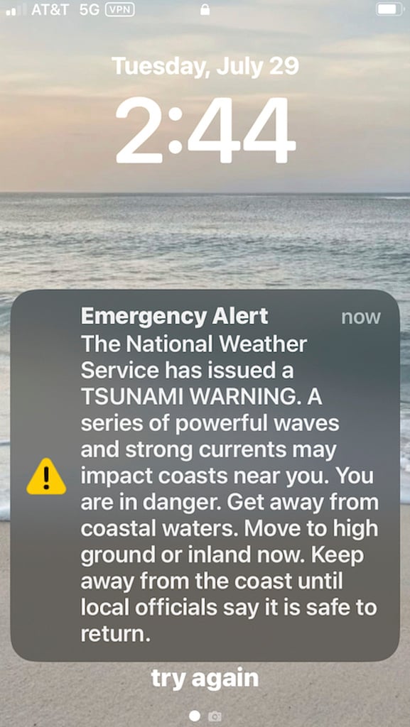 This screen shot shows a tsunami alert on a mobile photo in Honolulu Tuesday, July 29, 2025.