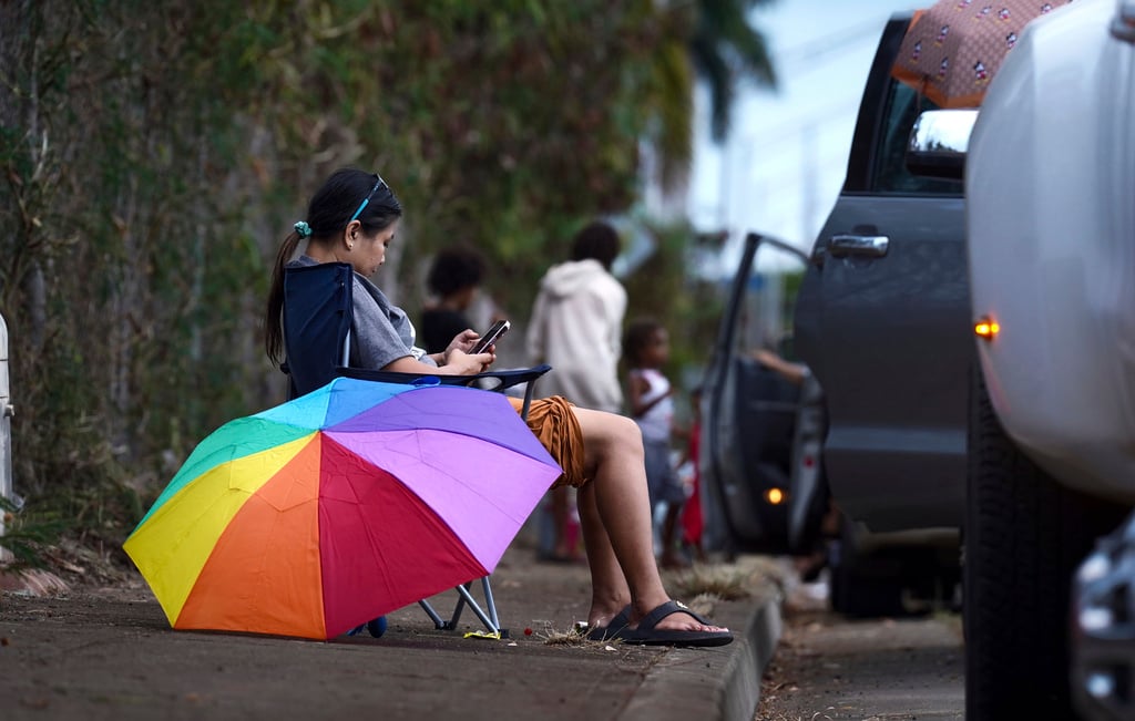 Ewa Beach residents evacuated to the side of Kunia Road to escape the tsunami threat in Kapolei, Oahu, Hawaii, Tuesday, July 29, 2025.