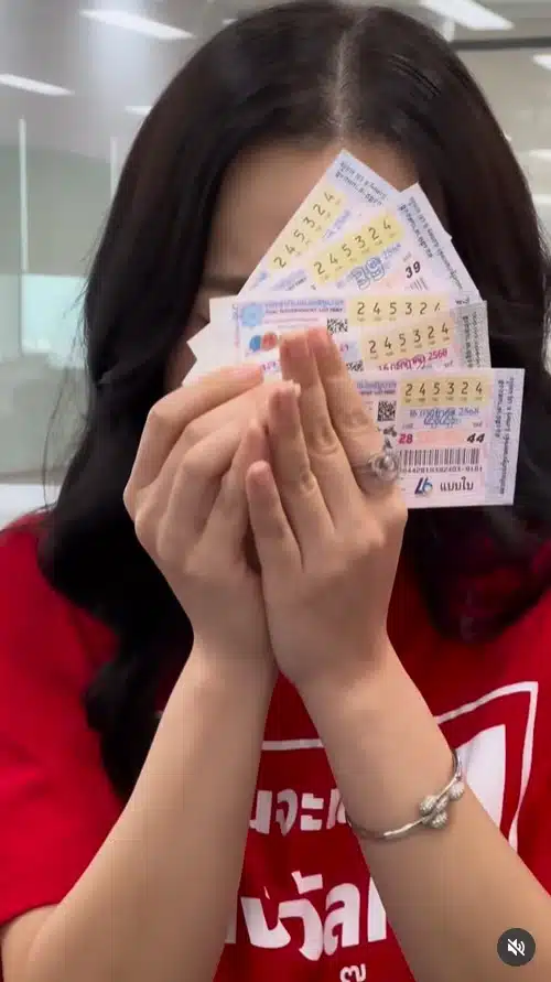 ภาพต้นหอม สกุนตลา เทียนไพโรจน์ กำลังถือสลากกินแบ่งรัฐบาลที่ถูกรางวัลที่ 1