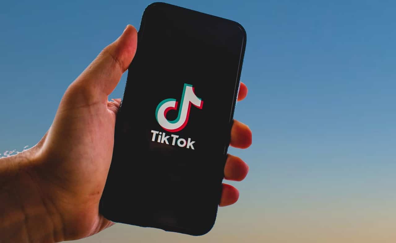 ภาพคนถือมือถือ แอปพลิเคชัน TikTok