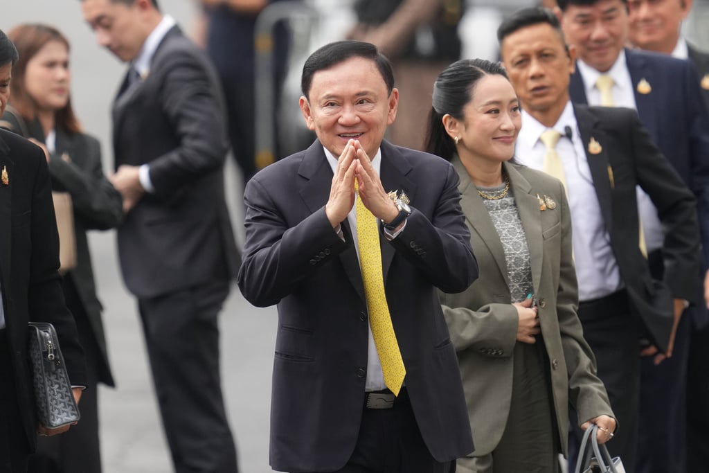 CORRECTS NAME OF DAUGHTER - Thailand's former Prime Minister Thaksin Shinawatra, center, and his daughter and former Prime Minister Paetongtarn Shinawatra, right, arrive at Supreme Court in Bangkok, Thailand, Tuesday, Sept. 9, 2025.