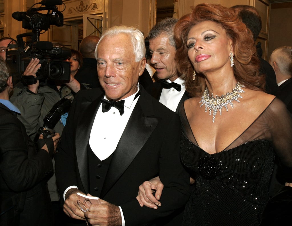 FILE - Italian actress Sophia Loren, right, and fashion designer Giorgio Armani arrive for the reopening of La Scala theater in Milan, Dec. 7, 2004.