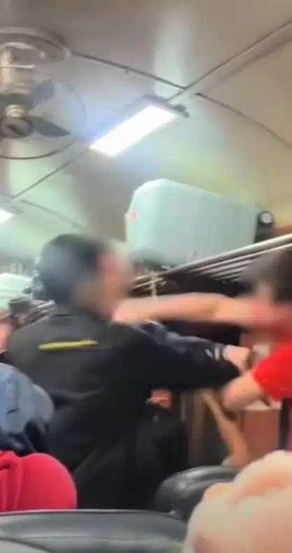 นักท่องเที่ยวชายชาวต่างชาติกำลังยืนโวยวายบนโบกี้รถไฟ