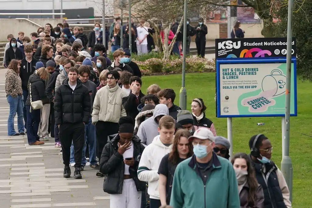 Students queue for antibiotics outside a building at the University of Kent, following an outbreak of meningitis, in Canterbury, Kent, England, Monday March 16, 2026.