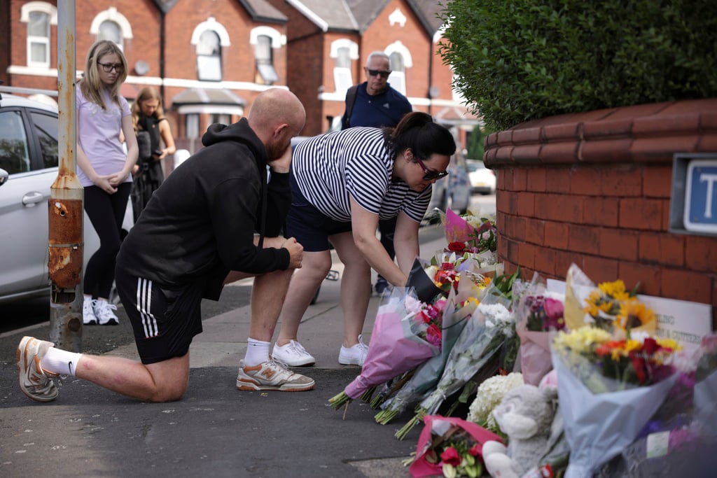 People leave flowers near the scene in Hart Street where two children died and nine were injured in a knife attack during a Taylor Swift event at a dance school on Monday, in Southport, England, Tuesday, July 30, 2024. Taylor Swift says she is “completely in shock” after two children died in a stabbing attack in a dance and yoga class themed on the singer. 