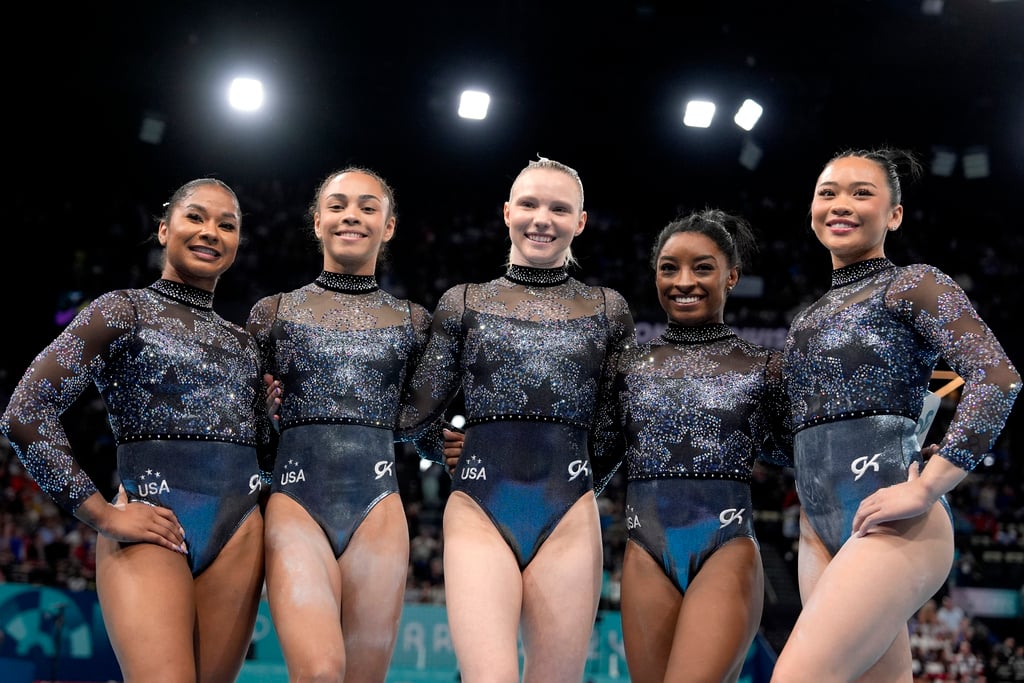 Team USA from left to right, Jordan Chiles, Hezly Rivera, Jade Carey, Simone Biles and Sunisa Lee, right, pose for photos after competing in a women's artistic gymnastics qualification round at Bercy Arena at the 2024 Summer Olympics, Sunday, July 28, 2024, in Paris, France. 