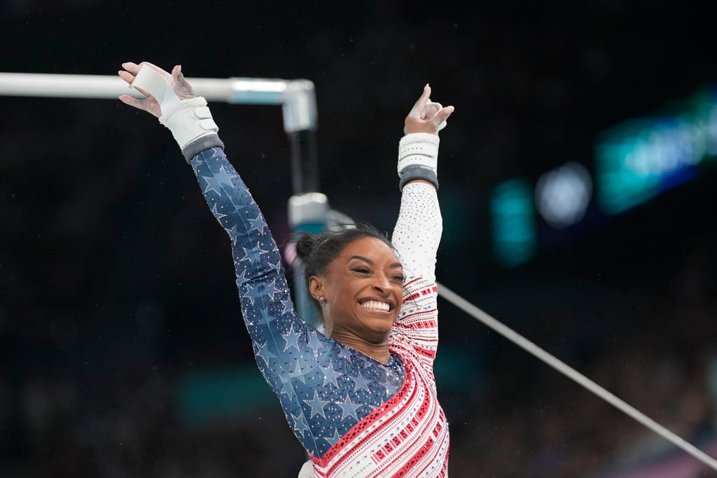 Simone Biles, of the United States, celebrates after performing on the uneven bars during the women's artistic gymnastics team finals round at Bercy Arena at the 2024 Summer Olympics, Tuesday, July 30, 2024, in Paris, France. 