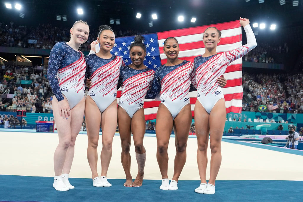 Team USA from left to right, Jade Carey, Suni Lee, Simone Biles, Jordan Chiles and Hezly Rivera celebrate after winning the gold medal during the women's artistic gymnastics team finals round at Bercy Arena at the 2024 Summer Olympics, Tuesday, July 30, 2024, in Paris, France. 