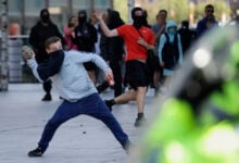 Police charge at protesters in Liverpool, England, Saturday Aug. 3, 2024, following the stabbing attacks on Monday in Southport, in which three young children were killed.