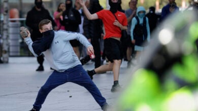 Police charge at protesters in Liverpool, England, Saturday Aug. 3, 2024, following the stabbing attacks on Monday in Southport, in which three young children were killed.