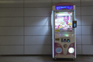 A claw machine sits inside a metro station in Rio de Janeiro, Wednesday, Aug. 28, 2024. The Rio police press office said they were carrying out search warrants targeting claw machines because they are considered games of chance and therefore illegal. (AP Photo/Hannah-Kathryn Valles).