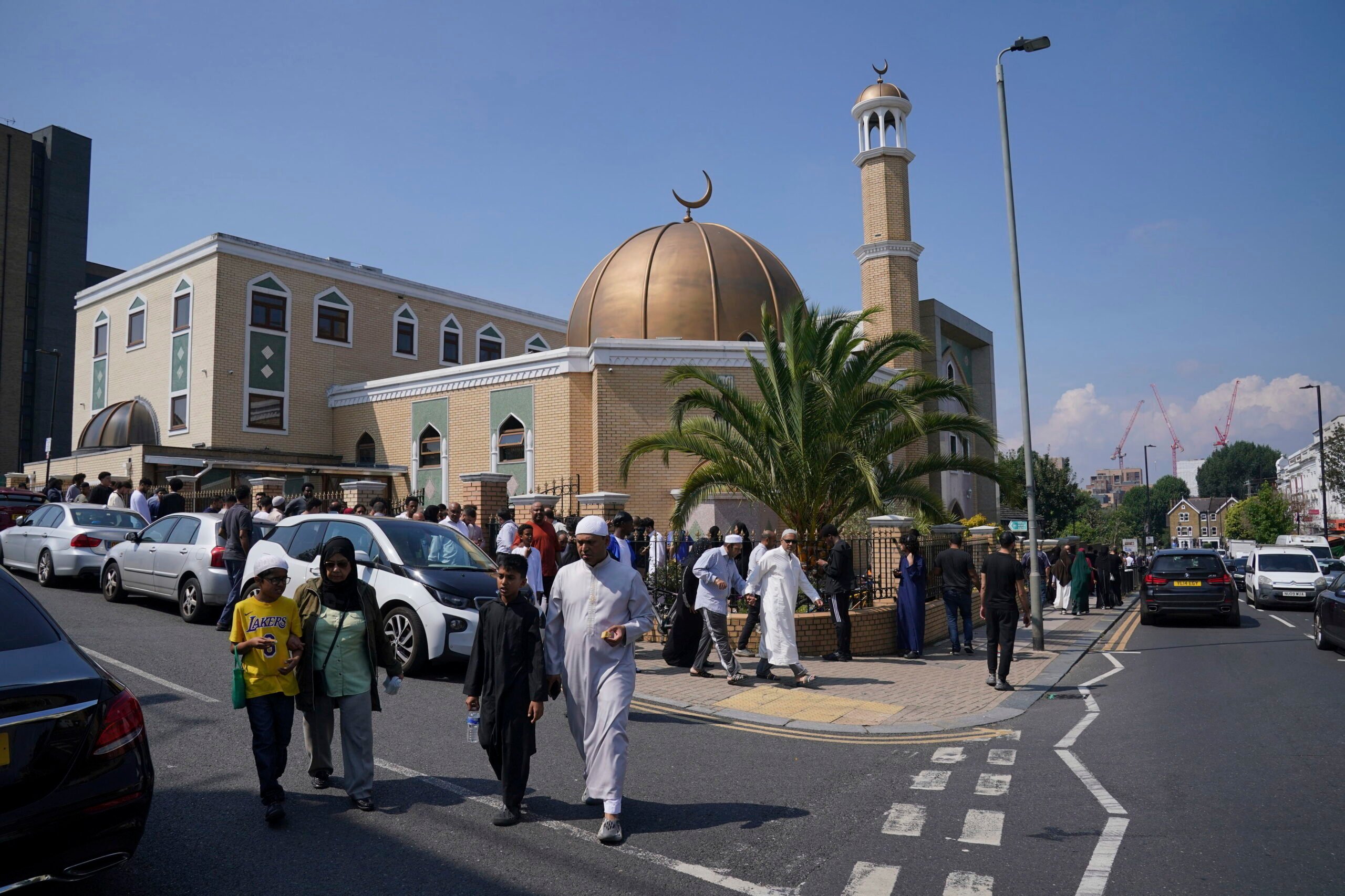 Worshippers leaves after taking part in Friday Prayers at the London Islamic Cultural Society (LICS) and Mosque in Haringey, north London, Friday, Aug. 2, 2024. Hundreds of mosques across the country are strengthening their security and protective measures ahead of planned protests, the Muslim Council of Britain (MCB) has said. There are fears that Islamic places of worship could be targeted during demonstrations expected to take place over the weekend following the Southport stabbing attack. (Jonathan Brady/PA via AP)