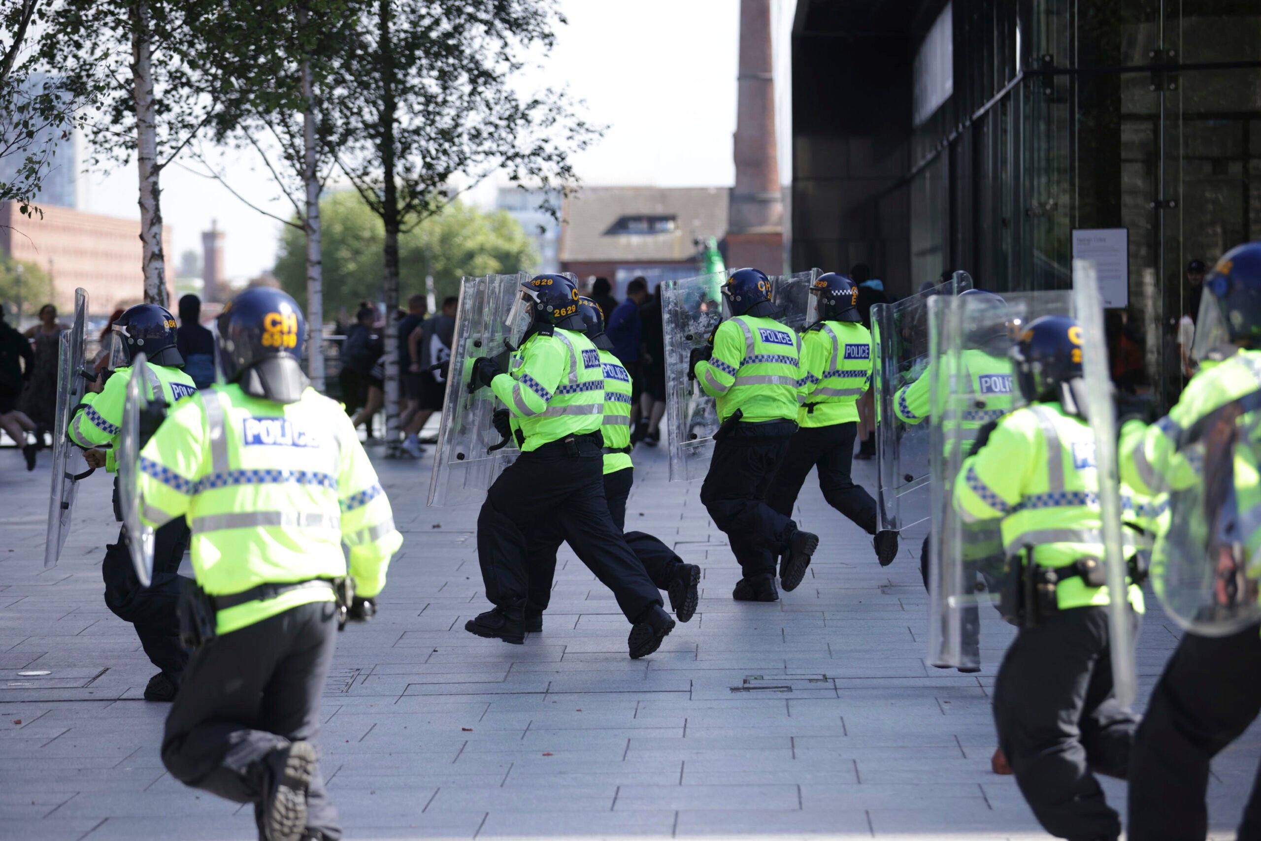 Police charge at protesters in Liverpool, England, Saturday Aug. 3, 2024, following the stabbing attacks on Monday in Southport, in which three young children were killed.