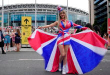 Fans of singer Taylor Swift, called Swifties, arrive at Wembley Stadium in London, Thursday, Aug. 15, 2024 for the first of five concerts of Taylor Swift's Eras Tour.(AP Photo/Alastair Grant).