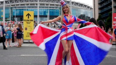 Fans of singer Taylor Swift, called Swifties, arrive at Wembley Stadium in London, Thursday, Aug. 15, 2024 for the first of five concerts of Taylor Swift's Eras Tour.(AP Photo/Alastair Grant).