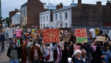 Counter protestors gather in Birmingham, England, Wednesday, Aug. 7, 2024 ahead of anti-immigration groups planning to target dozens of locations throughout the country following a week of rioting fueled by misinformation over a stabbing attack against young girls. (PA via AP)