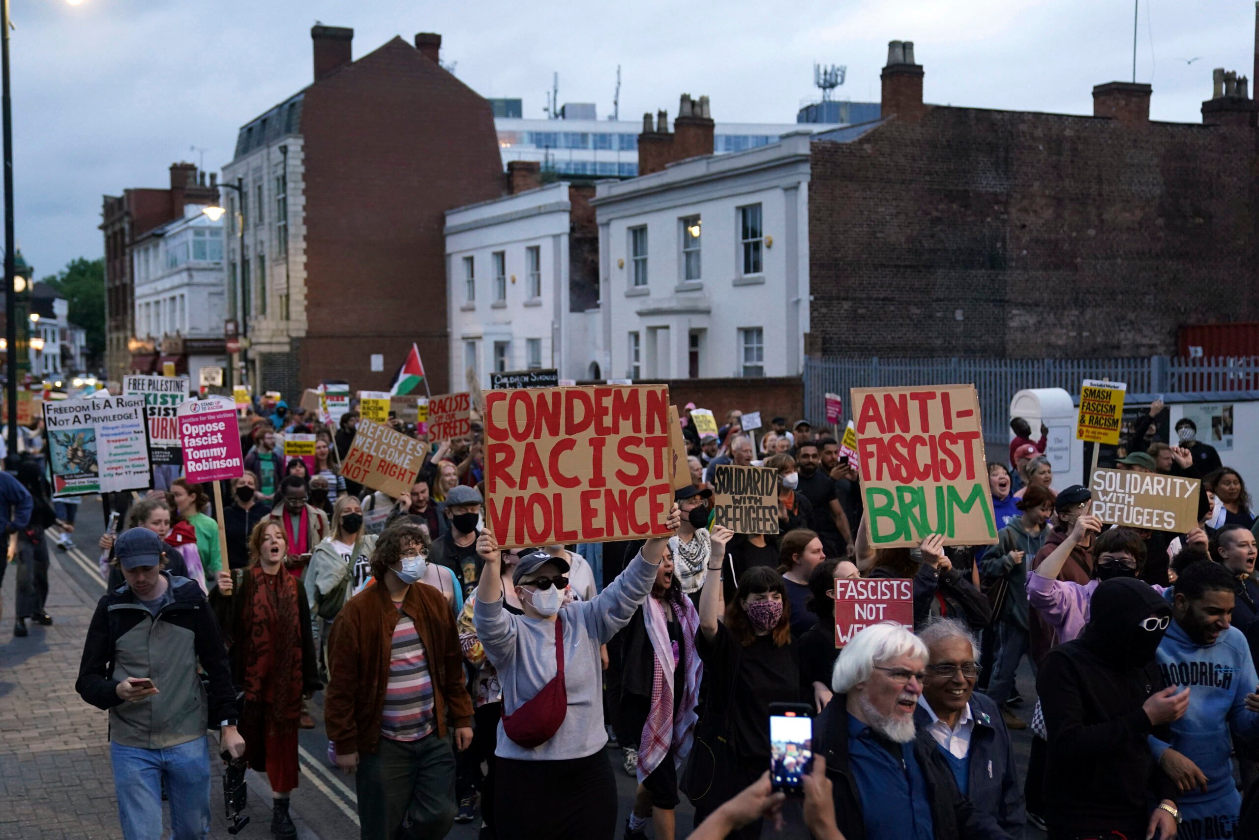 Counter protestors gather in Birmingham, England, Wednesday, Aug. 7, 2024 ahead of anti-immigration groups planning to target dozens of locations throughout the country following a week of rioting fueled by misinformation over a stabbing attack against young girls. (PA via AP)