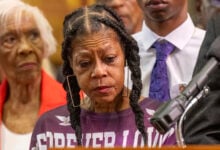 Tears stream down the face of Donna Massey as she listens to Attorney Ben Crump speak during a press conference over the shooting death of her daughter Sonya