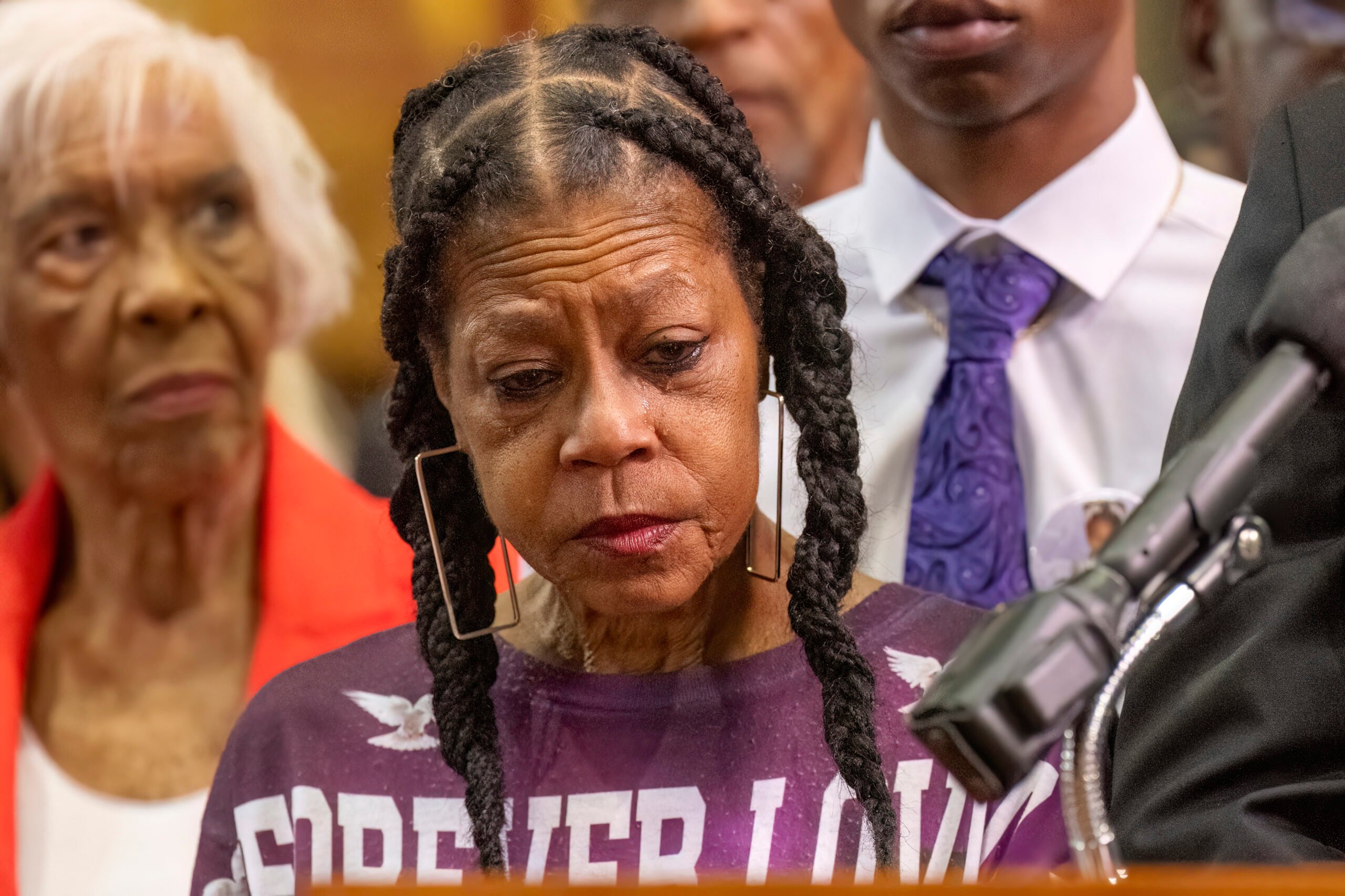 Tears stream down the face of Donna Massey as she listens to Attorney Ben Crump speak during a press conference over the shooting death of her daughter Sonya