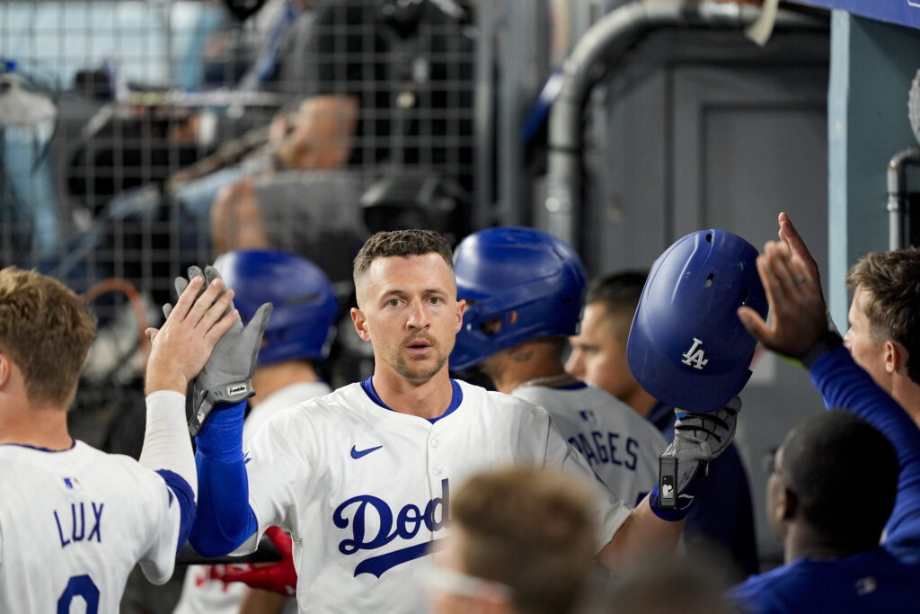 Los Angeles Dodgers' Nick Ahmed celebrates after scoring off a double hit by Freddie Freeman during the eighth inning of a baseball game against the San Francisco Giants, Wednesday, July 24, 2024, in Los Angeles. 