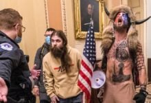 Judge orders return of QAnon Shaman's Capitol riot spear and helmet