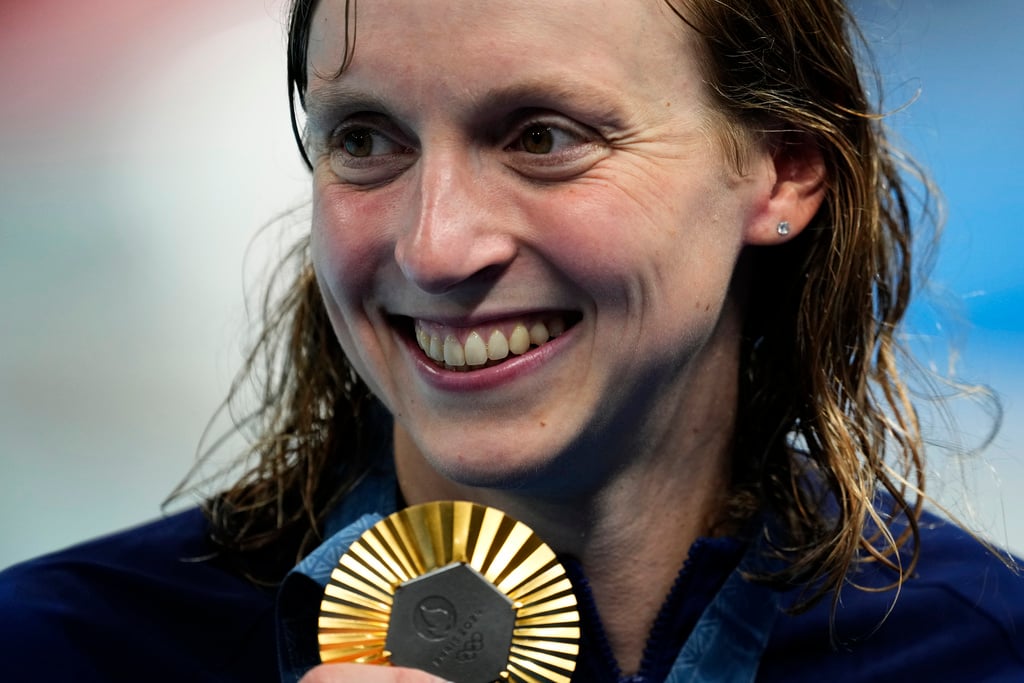 Katie Ledecky, of the United States, poses with her gold medal following the women's 1500-meter freestyle final at the 2024 Summer Olympics, Wednesday, July 31, 2024, in Nanterre, France. 