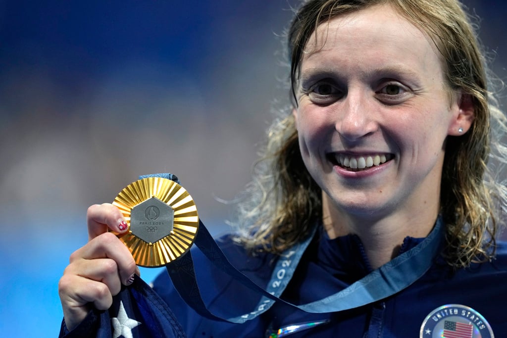 Gold medalist Katie Ledecky, of the United States, poses after the women's 1500-meter freestyle final at the 2024 Summer Olympics, Wednesday, July 31, 2024, in Nanterre, France.