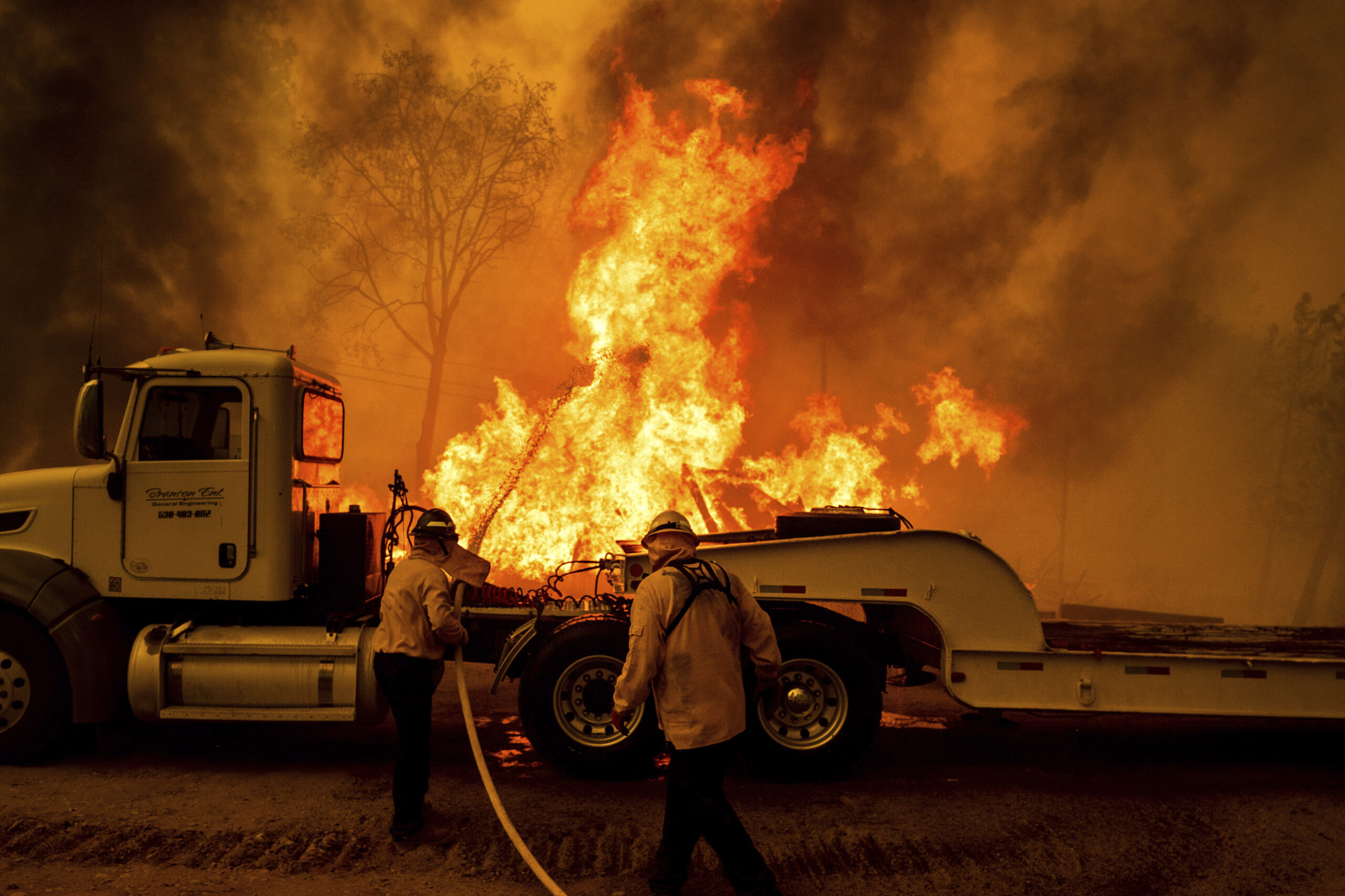 Firefighters spray water as the Park Fire