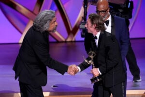 George Lopez, left, and Damon Wayans, right, present the award for outstanding lead actor in a comedy series to Jeremey Allen White, center, for "The Bear" during the 76th Primetime Emmy Awards on Sunday, Sept. 15, 2024, at the Peacock Theater in Los Angeles. (AP Photo/Chris Pizzello).