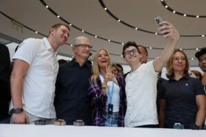 Apple CEO Tim Cook poses for a selfie with attendees after announcing new products at Apple headquarters Monday, Sept. 9, 2024, in Cupertino, Calif. (AP Photo/Juliana Yamada).