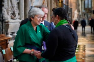 Former Prime Minister Theresa May, left and community volunteer Claire Walker speak before the Grenfell fire memorial service at Westminster Abbey, in remembrance of those who died in the Grenfell Tower fire in 2018, in London, Tuesday, June 14, 2022. (Jonathan Brady/Pool via AP, File).