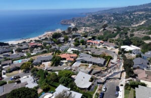 Slide damage on Dauntless Dr., lower right, in Rancho Palos Verdes on Tuesday, Sept. 3, 2024. Gov. Gavin Newsom has proclaimed a state of emergency in Rancho Palos Verdes where worsening landslide conditions have led to residents having electrical and gas service cut off. The proclamation is aimed at freeing up state resources to assist in the response to the slides. (Dean Musgrove/The Orange County Register via AP).