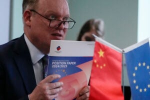 President of the European Union Chamber of Commerce in China Jens Eskelund holds a copy of the annual European Business in China Position Paper during a press conference in Beijing, Wednesday, Sept. 11, 2024. (AP Photo/Andy Wong).