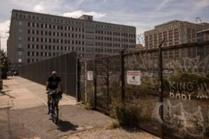 A person cycles past the Metropolitan Detention Center in the Sunset Park neighborhood of the Brooklyn borough of New York, Thursday, Sept. 19, 2024. (AP Photo/Yuki Iwamura).