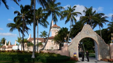 Security agents talk at the entrance to former President Donald Trump's Mar-a-Lago estate, March 31, 2023, in Palm Beach, Fla. (AP Photo/Rebecca Blackwell, File).