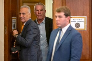 Former NFL quarterback Brett Favre, center, arrives to appear before the House Committee on Ways and Means on Capitol Hill, Tuesday, Sept. 24, 2024, in Washington. (AP Photo/Mark Schiefelbein).