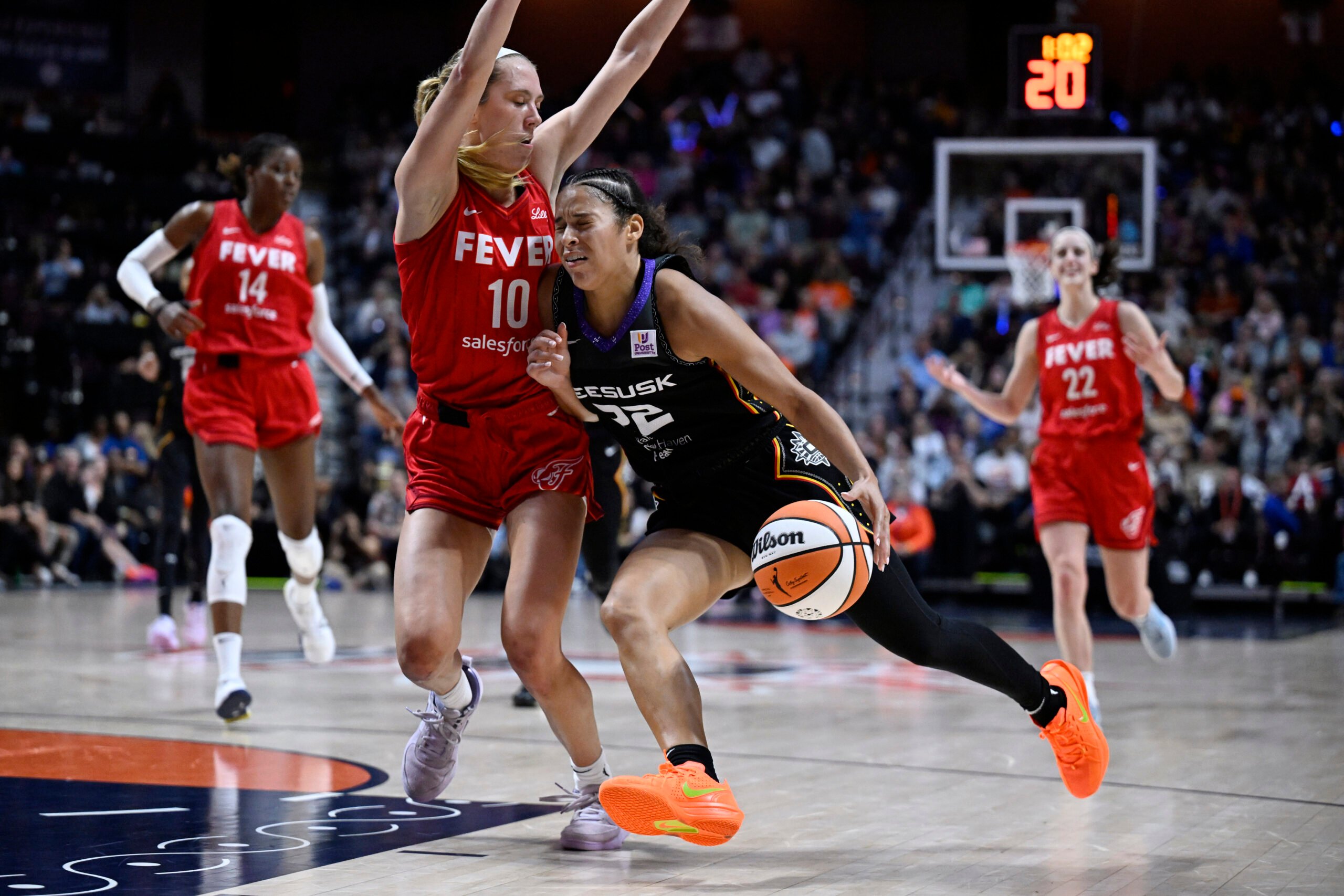 Connecticut Sun guard Veronica Burton (22) drives to the basket as Indiana Fever guard Lexie Hull (10) defends during the second half in Game 2 of a first-round WNBA basketball playoff series, Wednesday, Sept. 25, 2024, in Uncasville, Conn. (AP Photo/Jessica Hill).