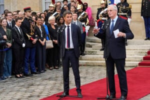 New French prime minister Michel Barnier, right, and outgoing prime minister Gabriel Attal deliver a speech during the handover ceremony, Thursday, Sept. 5, 2024 in Paris. President Emmanuel Macron has named EU's Brexit negotiator Michel Barnier as France's new prime minister after more than 50 days of caretaker government. (AP Photo/Michel Euler).