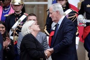 New French prime minister Michel Barnier, right, is greeted by France's outgoing Minister for Labour, Health and Solidarities Catherine Vautrin, left, during the handover ceremony, Thursday, Sept. 5, 2024 in Paris. President Emmanuel Macron has named EU's Brexit negotiator Michel Barnier as France's new prime minister after more than 50 days of caretaker government. (Stephane de Sakutin/Pool Photo via AP).