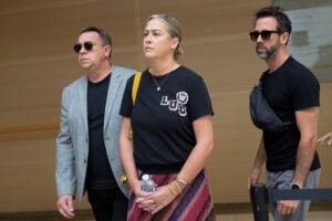 The sons of Gisele Pelicot, Florian, right, David, left, and her daughter Caroline Darian, center, arrive in the Avignon court house, southern France, Thursday, Sept. 5, 2024. (AP Photo/Lewis Joly).