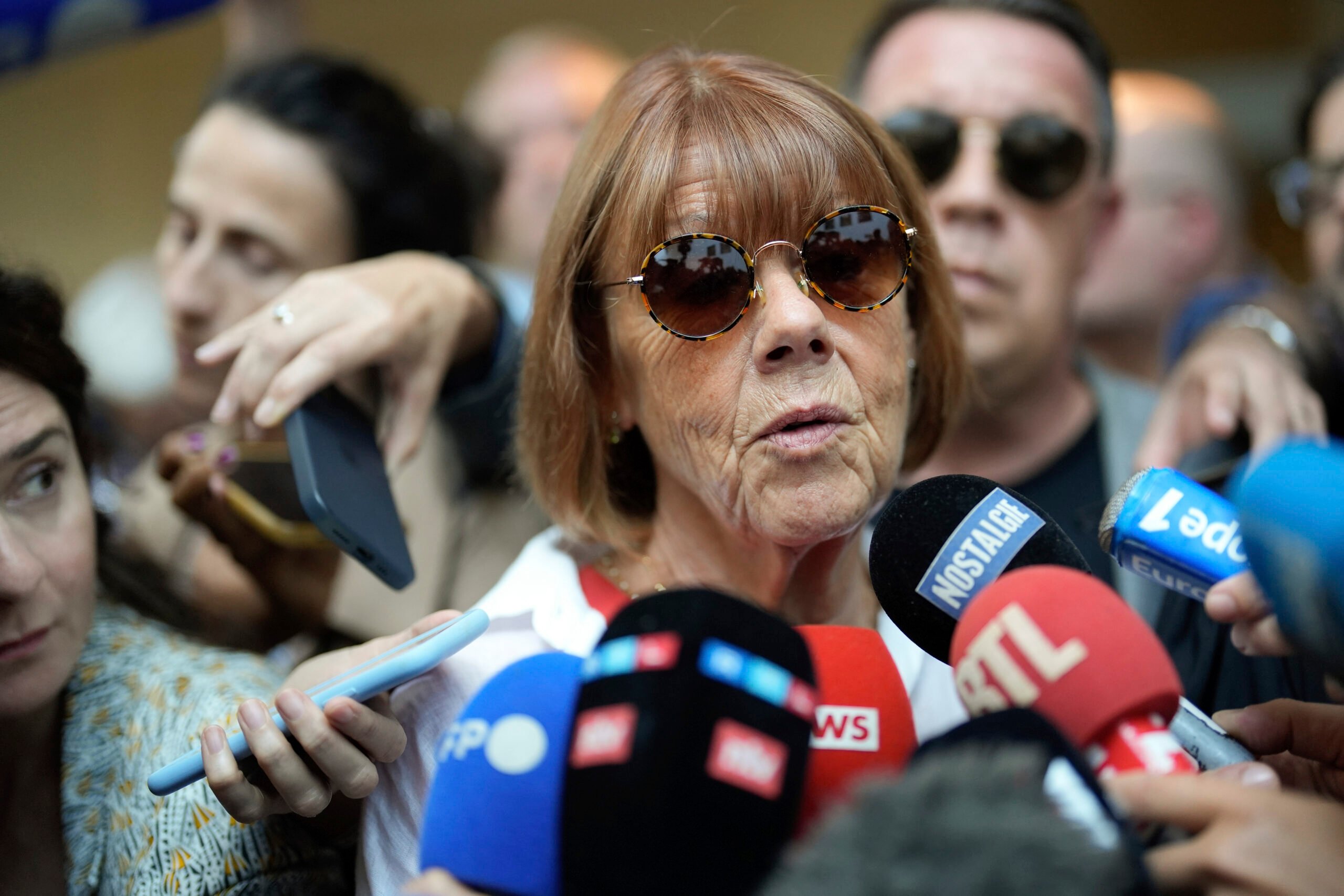 Gisele Pelicot speaks to media as she leaves the Avignon court house, southern France, Thursday, Sept. 5, 2024. A woman allegedly drugged by her ex-husband so that she could be raped by other men while she laid unconscious, is expected to testify before a panel of French judges. (AP Photo/Lewis Joly).