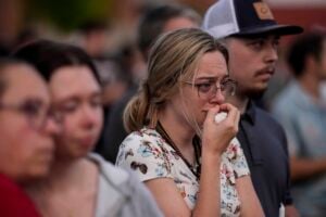 Mourners pray during a candlelight vigil for the slain students and teachers at Apalachee High School, Wednesday, Sept. 4, 2024, in Winder, Ga. (AP Photo/Mike Stewart).