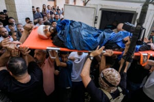 Mourners, some armed, carry the bodies of five Palestinians during their funeral in Tubas, West Bank, Thursday, Sept. 5, 2024. Palestinian health officials say Israeli strikes in the occupied West Bank killed five people. Israel has been carrying out large-scale raids in the territory over the past week that it says are aimed at dismantling militant groups and preventing attacks. (AP Photo/Majdi Mohammed).